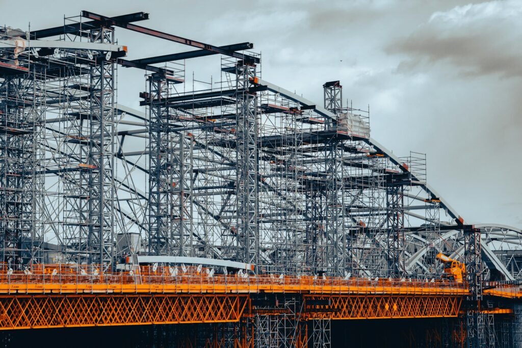 Steel truss structure being built on a bridge